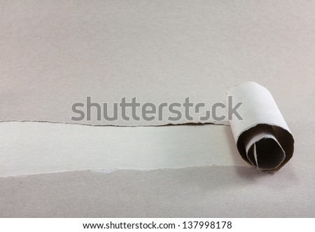 Brown package paper torn to reveal white panel