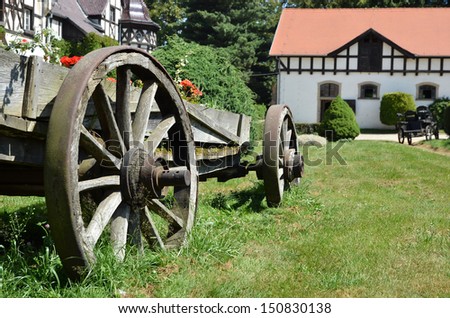Ancient cart with wooden wheels in a farm