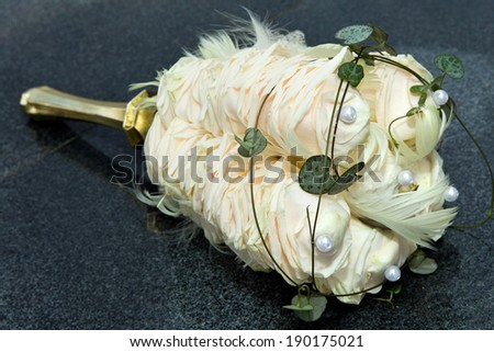 Unusual Bouquet of rose petals with feathers and artificial pearls for wedding ceremony
