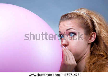 young girl inflates the balloon funny