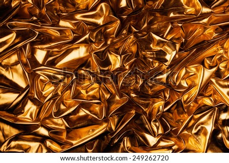 abstract background luxury cloth or liquid wave or wavy folds of grunge Lame gold texture satin velvet material or luxurious
