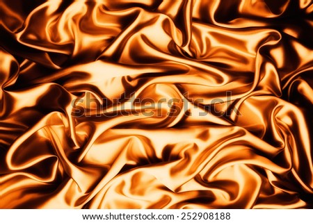 abstract background luxury cloth or liquid wave or wavy folds of grunge gold silk texture satin velvet material or luxurious