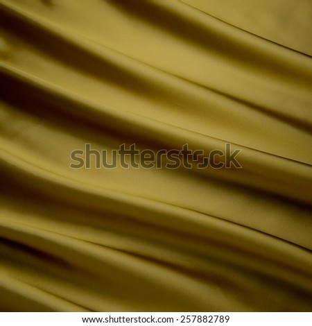 abstract background luxury cloth or liquid wave or wavy folds of grunge gold silk texture satin velvet material or luxurious