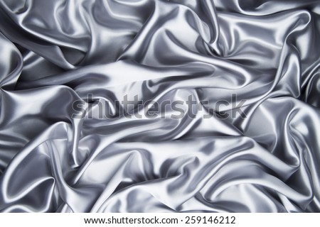 abstract background luxury cloth or liquid wave or wavy folds of grunge silver silk texture satin velvet material or luxurious