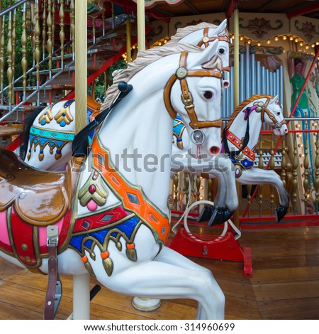 CANNES, FRANCE - AUGUST 01,2015: Vintage merry-go-round with horses and other animals for kids at Croisette promenade on August 01,2015 in Cannes, France.