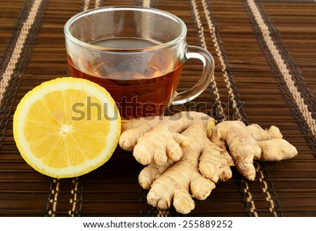 Ginger tea on brown mat with lemon with ginger