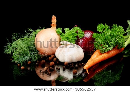 Onions,red onions,dill,pepper,allspice,garlic and carrots isolated on black background