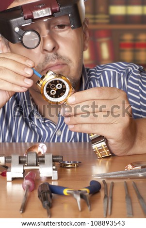 Watch repair craftsman repairing watch. Focus on watch