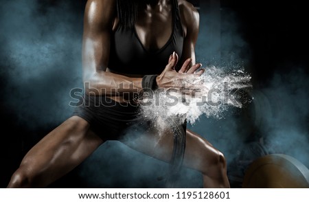 Woman clapping hands and preparing for workout at a gym
