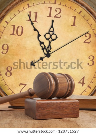 Wooden gavel and old vintage clock