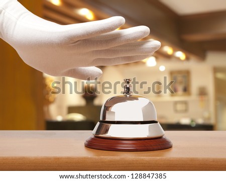 Hand of a man using a hotel bell