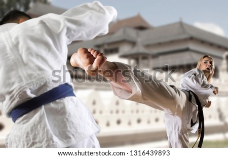 Caucasian female in kimono practicing taekwondo. Modern Korean martial art similar to karate