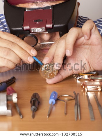 Watch repair craftsman repairing watch. Focus on face watchmaker