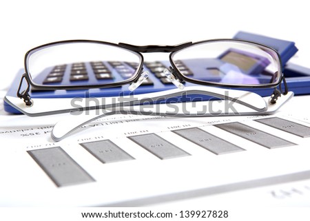 Glasses on paper table with finance report