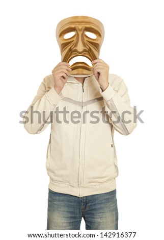 A man holds a golden theatrical mask of tragedy
