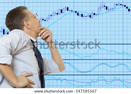 Stock trader looking at monitors