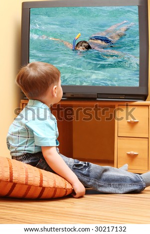 Little boy watching cinema on TV. TV screen -  photo of the author 