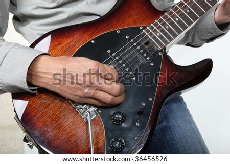 man playing electrical guitar
