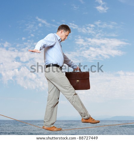 Businessman rope-walker