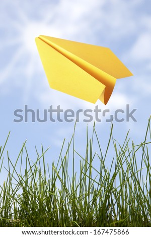 Yellow paper plane in the sky