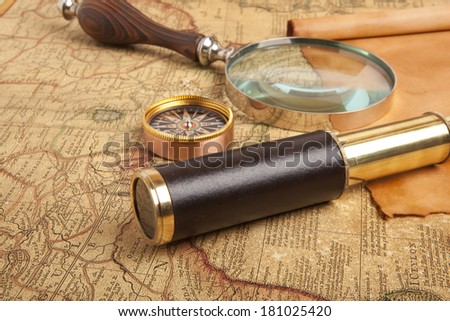 Vintage brass telescope on old antique map