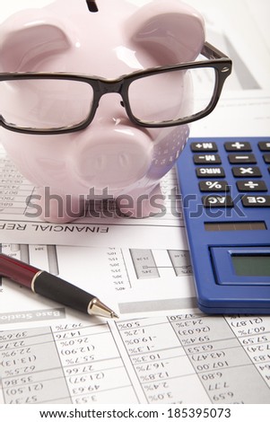 Pink piggy bank and calculator