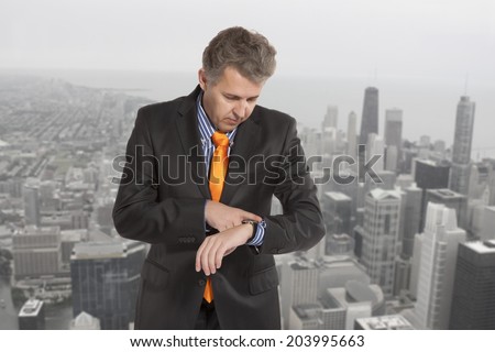 Checking the time. Worried adult businessman