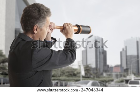 Business concept.  Business man looks through a telescope