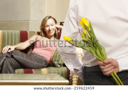 Man giving flowers to woman. Focus on the man