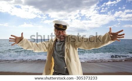Captain. Happy sailor man on ocean background