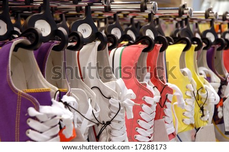 Many pair of sneakers in a store