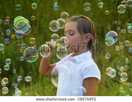 blowing soap bubbles