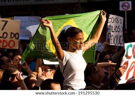 Sao Paulo, Brazil - June 22. Student carrying the flag of Brazil on her back during the protests in Brazil on June against corruption in government on June 22th,2013 in Sao Paulo, Brazil.