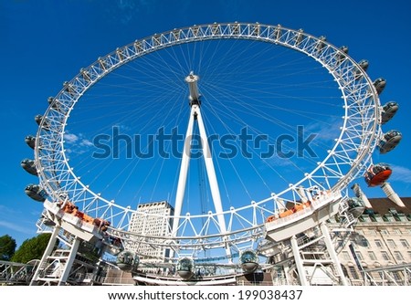 London, England - May 25, 2014: London Eye is a famous tourist attraction at a height of 135 metres (443 ft) the biggest Ferris wheel in Europe.