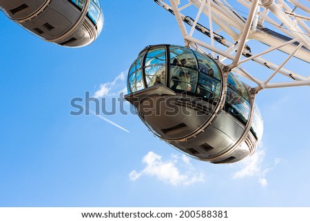 LONDON, ENGLAND - MAY 25, 2014: London Eye is a famous tourist attraction at a height of 135 metres (443 ft) the biggest Ferris wheel in Europe. Also called Milleniun Wheel, in may 25,2014