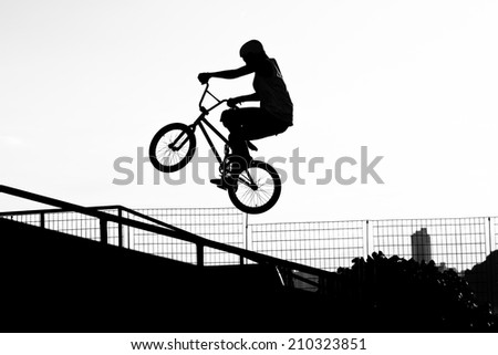 Girl jumping with bike in a skate park