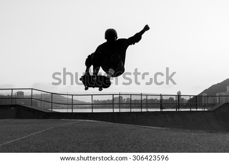 skateboarder jumping in a bowl of a skate park