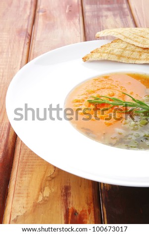 european cuisine: dual components vegetable soup with toasts over wood