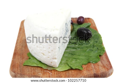 roquefort cheese on wooden platter with olives and tomato isolated over white background