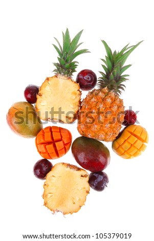 exotic fruit food - a lot of fresh raw tropical fruits include pineapple mango and red plums isolated over white background