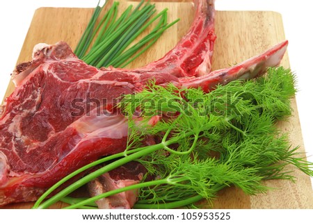 fresh meat : raw beef spare ribs with dill and fresh green chives on wooden board isolated over white background
