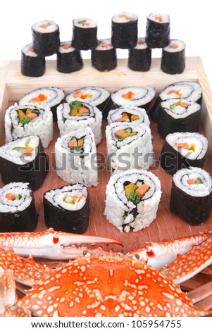 California Roll with Avocado and Salmon, Cream Cheese and Raw Salmon inside. on wooden plate with live crab  . isolated over white background . Maki Sushi and Sashimi