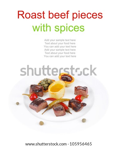 european food: grilled meat goulash on white plate with hot pepper, capers and sauces