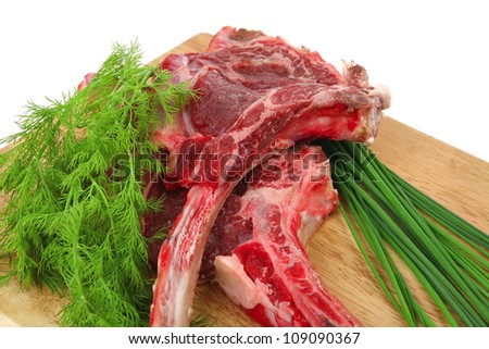 fresh raw meat : fresh red beef ribs with dill and green sprouts on wooden board isolated over white background