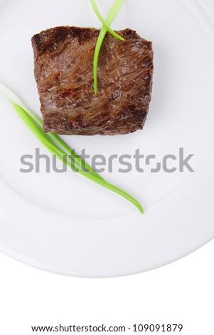 meat food : roast beef fillet mignon served on white plate with green sprouts isolated over white background
