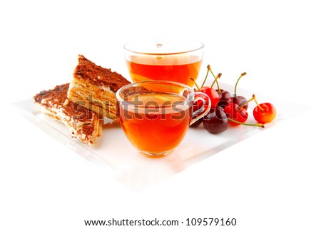 black english tea and cakes with red cherry