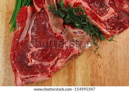 fresh raw meat : fresh red beef ribs with green sprouts on wooden board isolated over white background