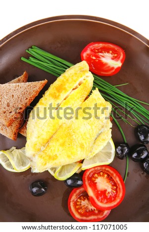 roast fish fillet with tomatoes,chives and bread on plate
