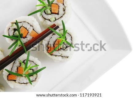 Japanese Cuisine - California Sushi Roll with Avocado, Cream Cheese and Raw Salmon inside. With wasabi and ginger. isolated over white background