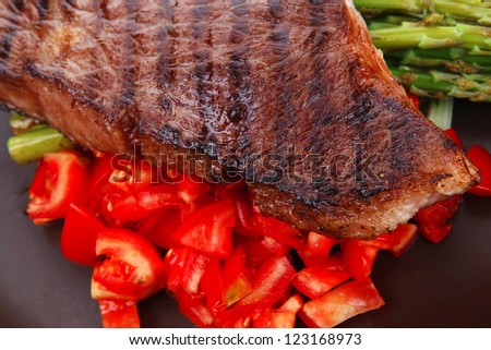 meat table : rare medium roast beef fillet with tomatoes and asparagus served on dish isolated over white